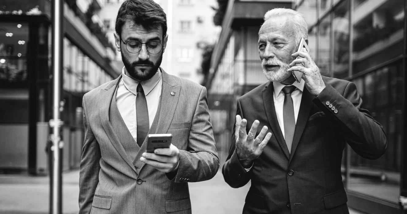 Two business owners working on their phones