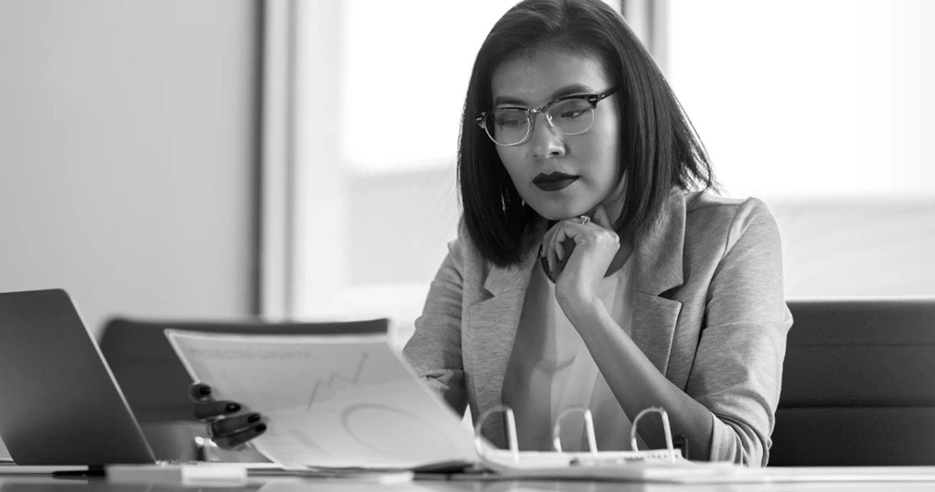 A woman watching a webinar on her laptop