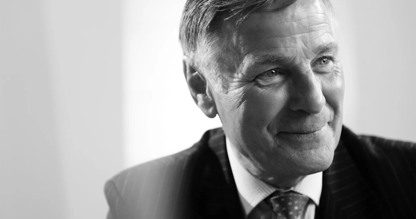 A man in a meeting wearing a suit