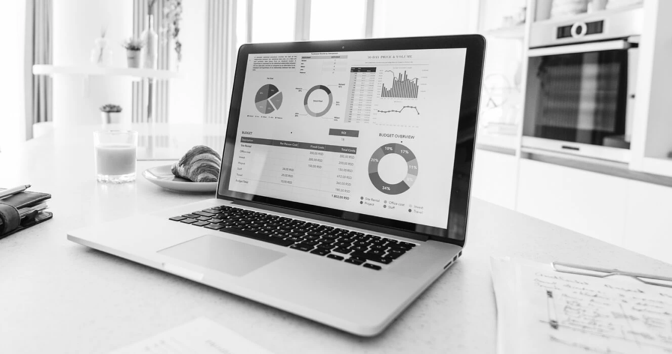 A laptop opened with some financial information on the screen