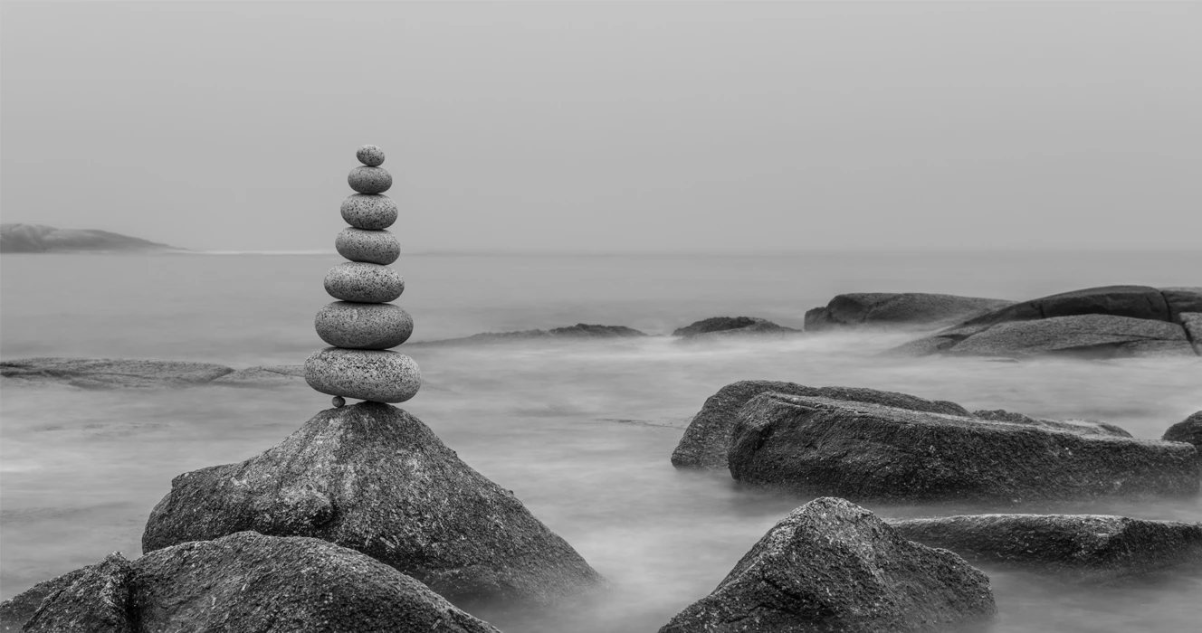 Rocks piled on top of each other near a coastal edge